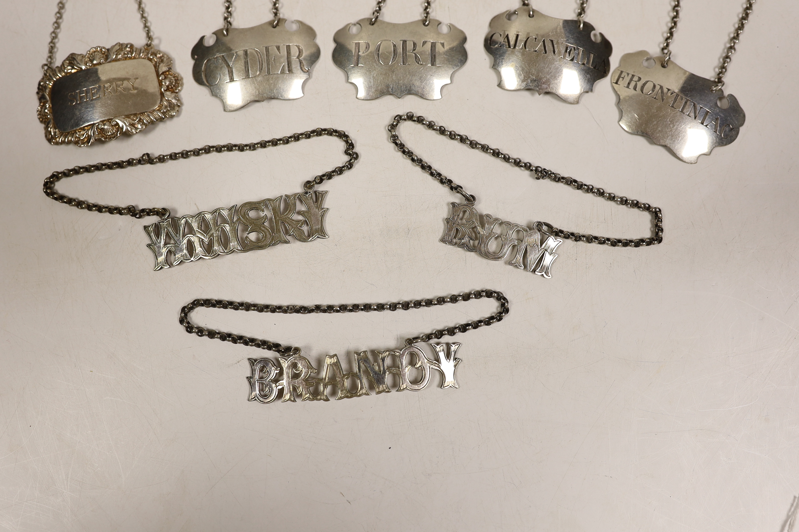 Four assorted 19th century white metal wine labels including pair 'Calcavella' & 'Port' by John Harvey I, London, circa 1750 and four assorted plated wine labels.